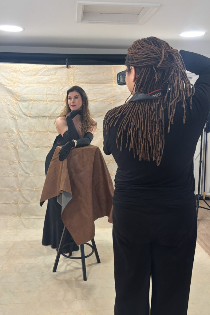 Woman being guided at a luxury portrait photoshoot looking relaxed and confident