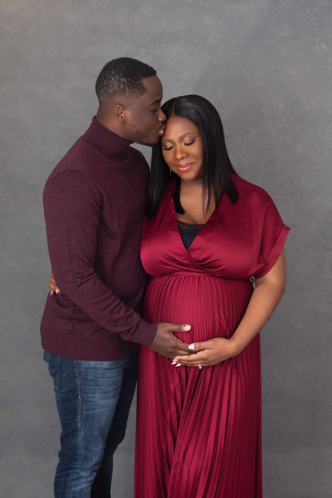Pregnant woman in a luxury gown during a motherhood portrait session, Buckinghamshire