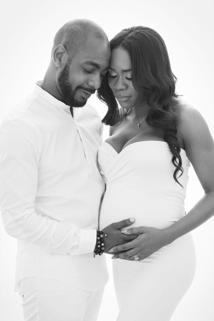 Black and white motherhood portrait of a pregnant woman in a studio, Milton Keynes